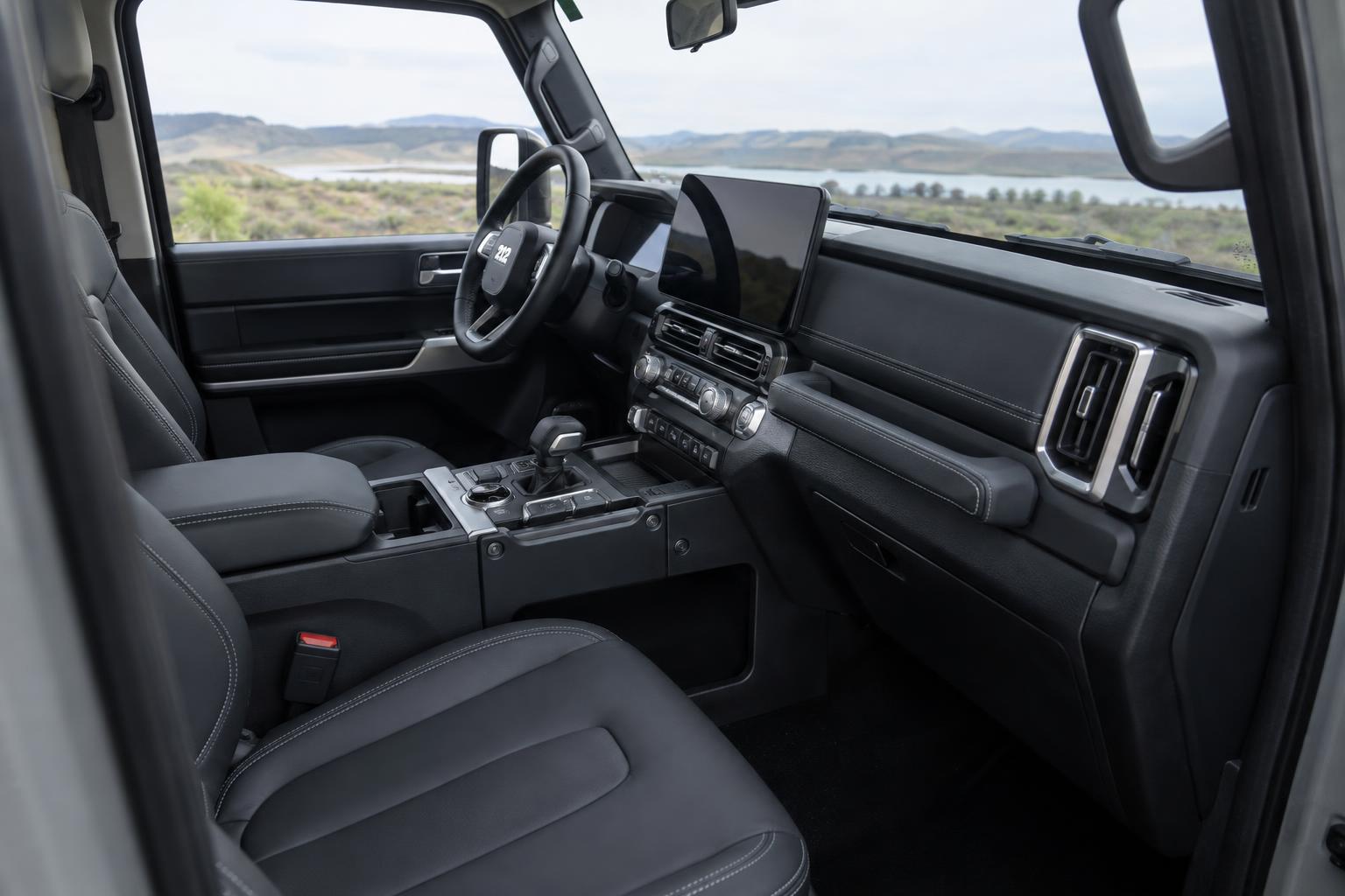 Front cabin of the 212 T01 Adventurer showing the dashboard, centre console and front seats.
