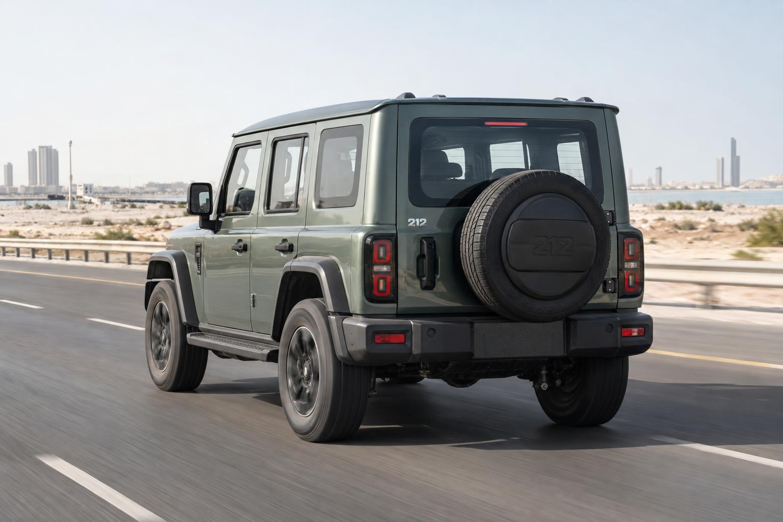 Rear three-quarter view of a 212 T01 Adventurer driving on an open road in Bahrain.