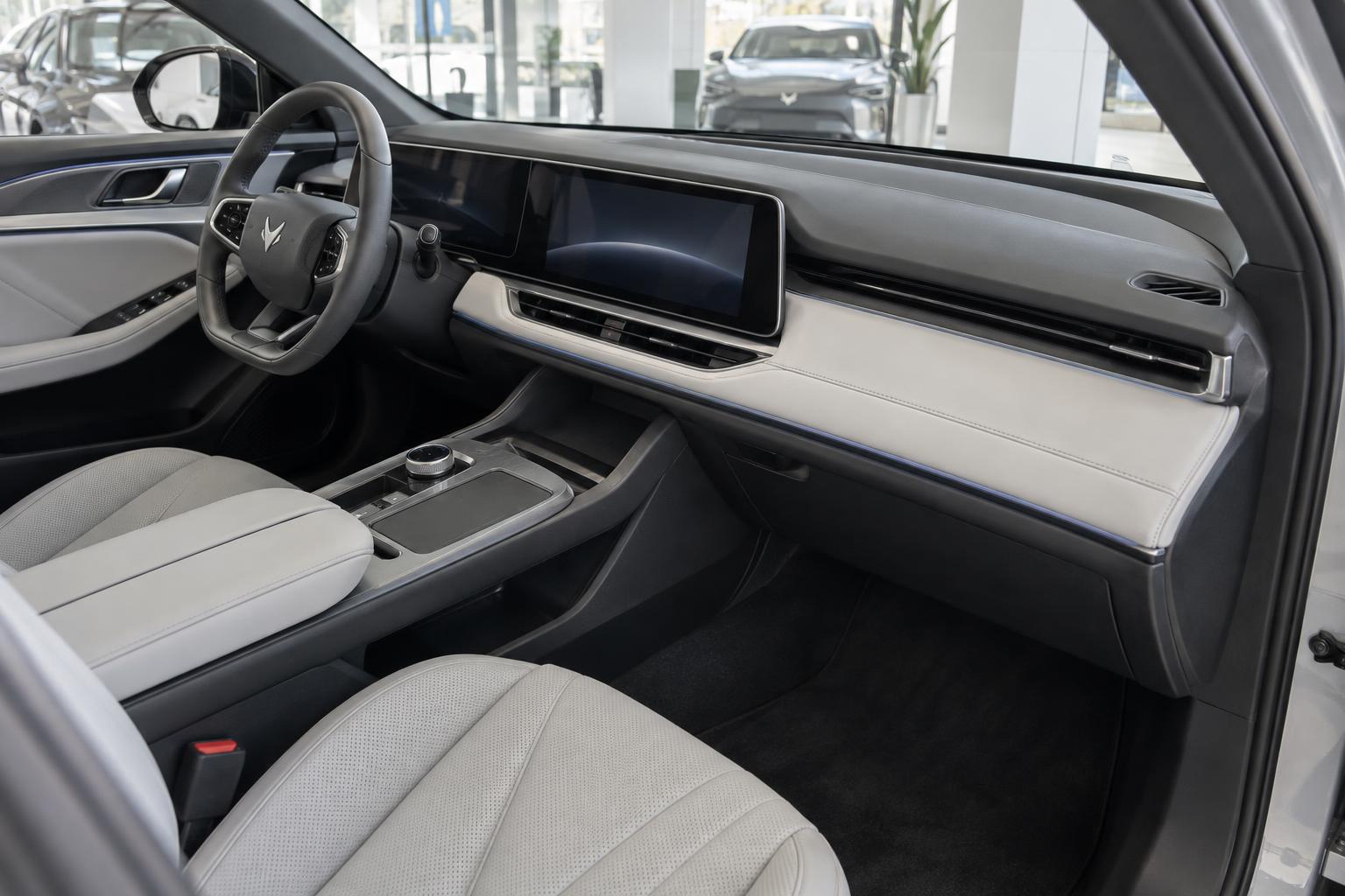 The front cabin of an Arcfox electric vehicle, showing its dashboard, steering wheel and centre console.