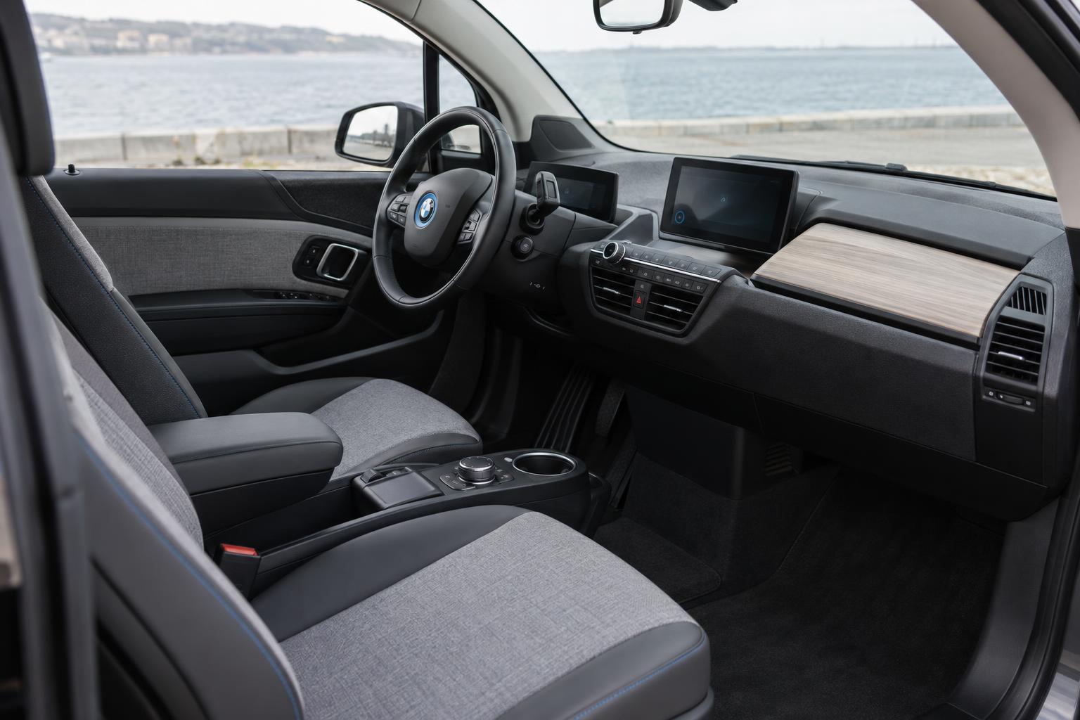 View across the front cabin of the new BMW i3 showing its dashboard, steering wheel and center console.