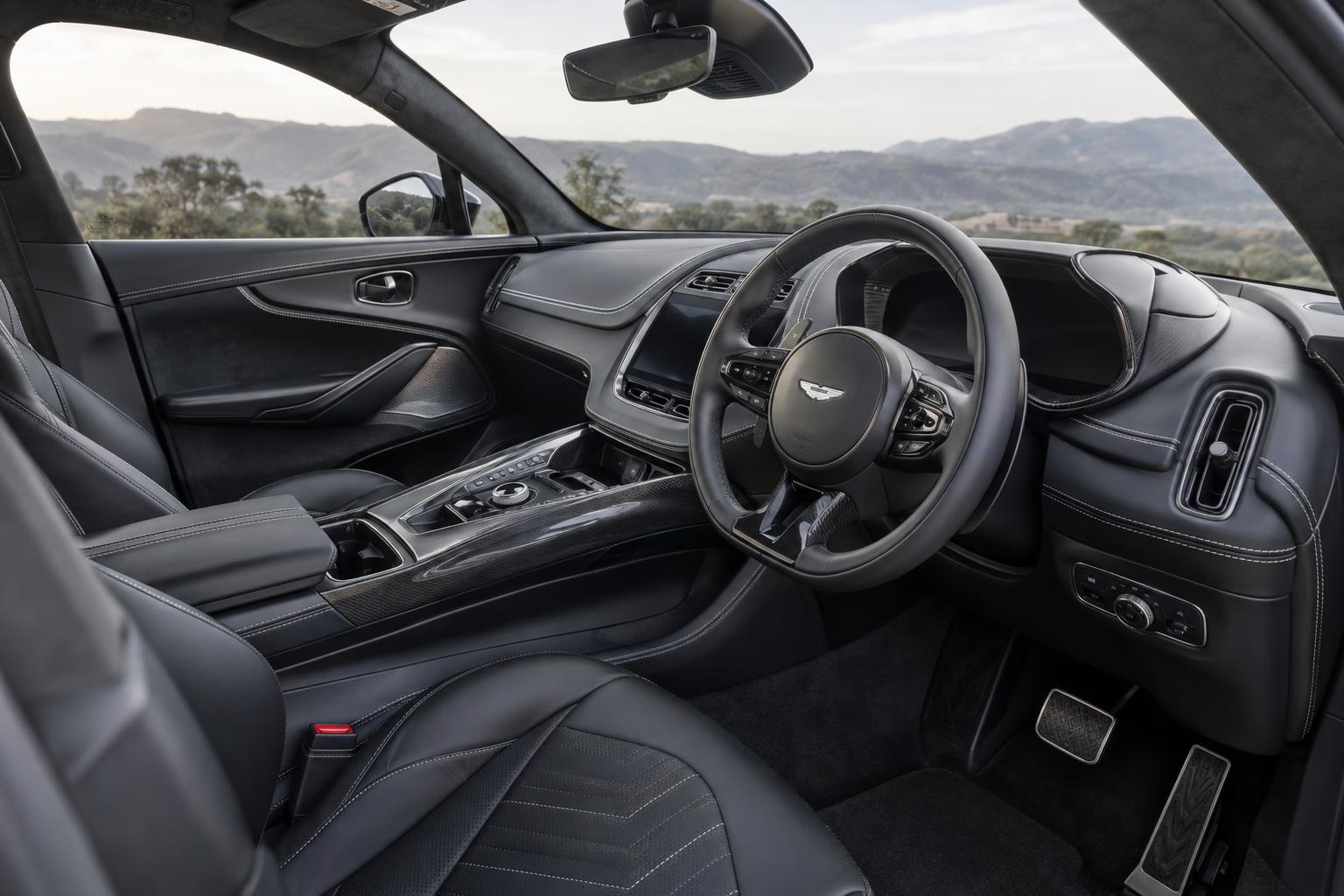 View across the Aston Martin DBX GT cabin showing its leather-trimmed seats and dashboard.