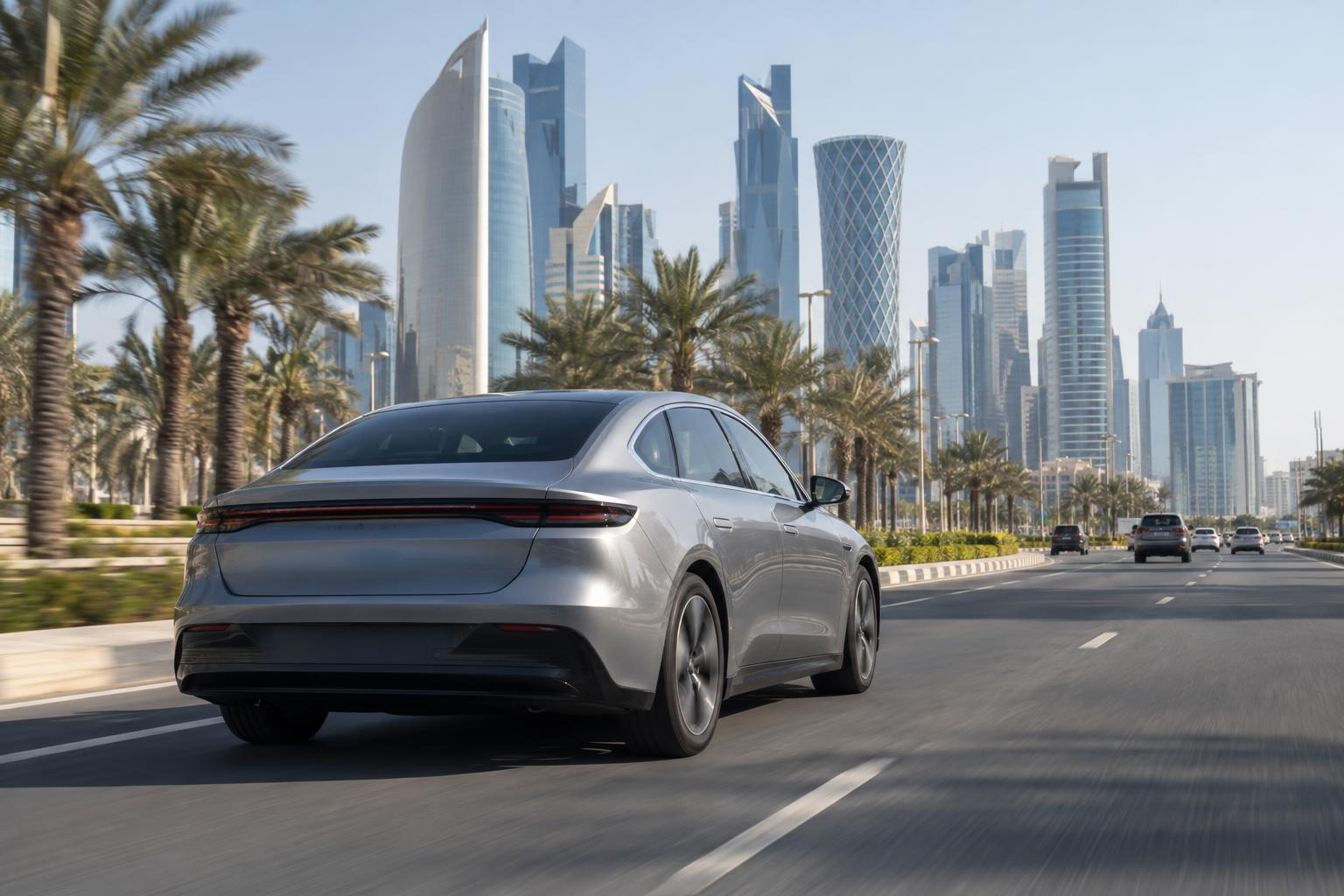 An electric sedan driving on a modern urban road in Doha.