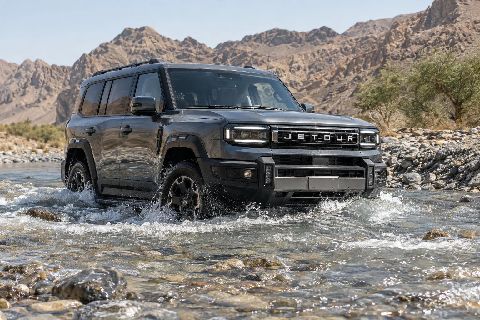 Jetour G700 TopFire crossing a rocky desert water channel.