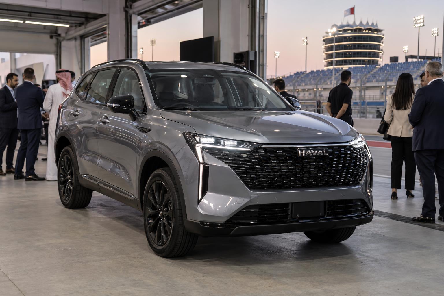 A redesigned Haval H6 is presented to guests in a Bahrain International Circuit pit-garage setting.