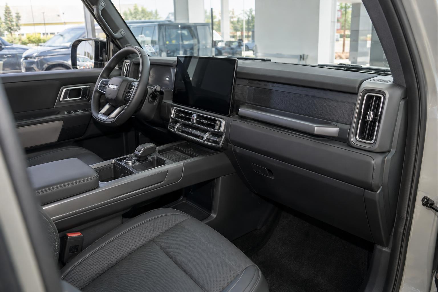 View across the dashboard and front seats of an updated iCAUR V27 in the Jeddah showroom.