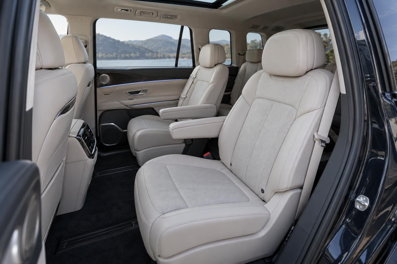 View into the IM LS9 cabin showing the second-row seats and access toward the third row.