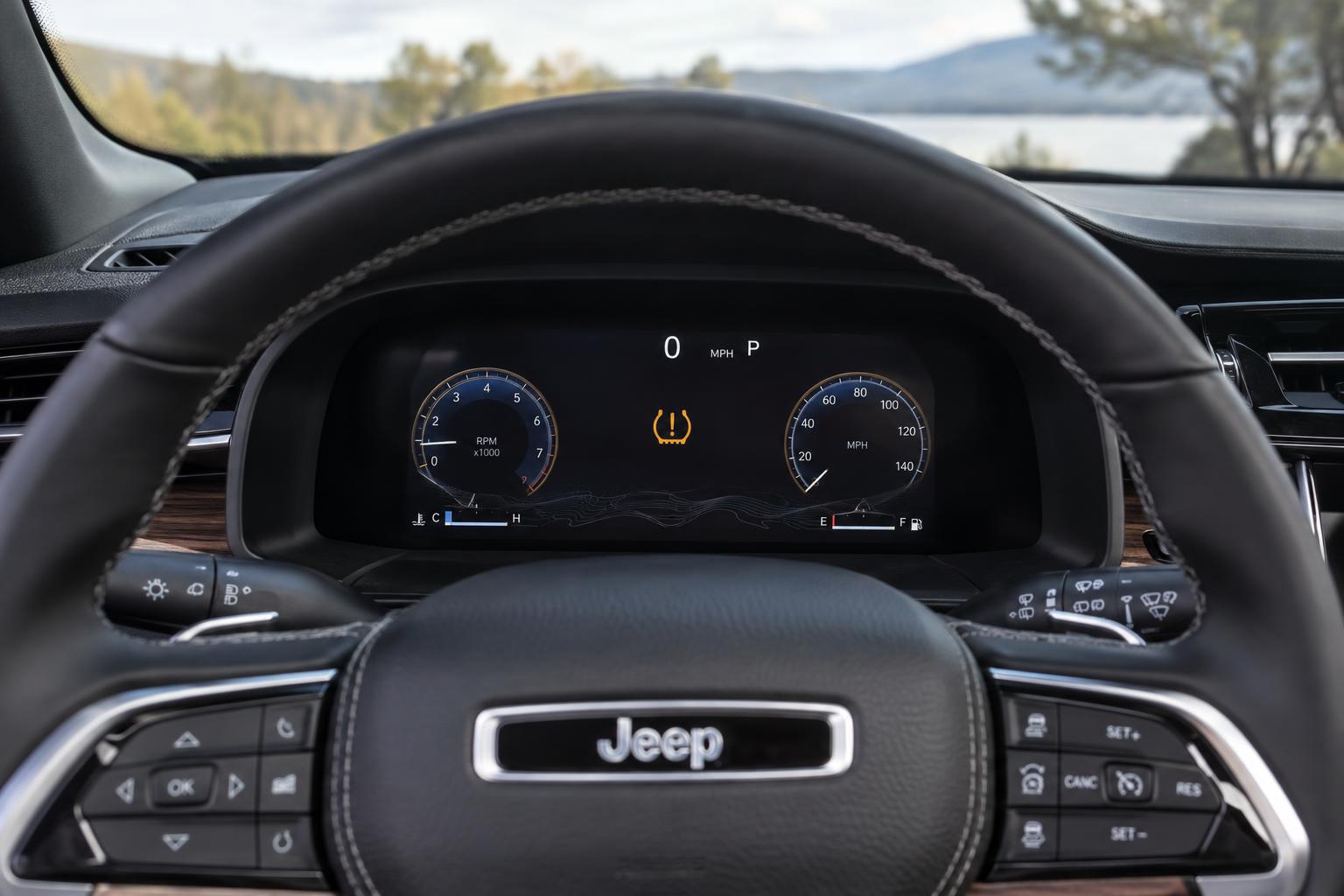 Low tyre-pressure warning symbol on the instrument display of a Jeep Grand Cherokee.