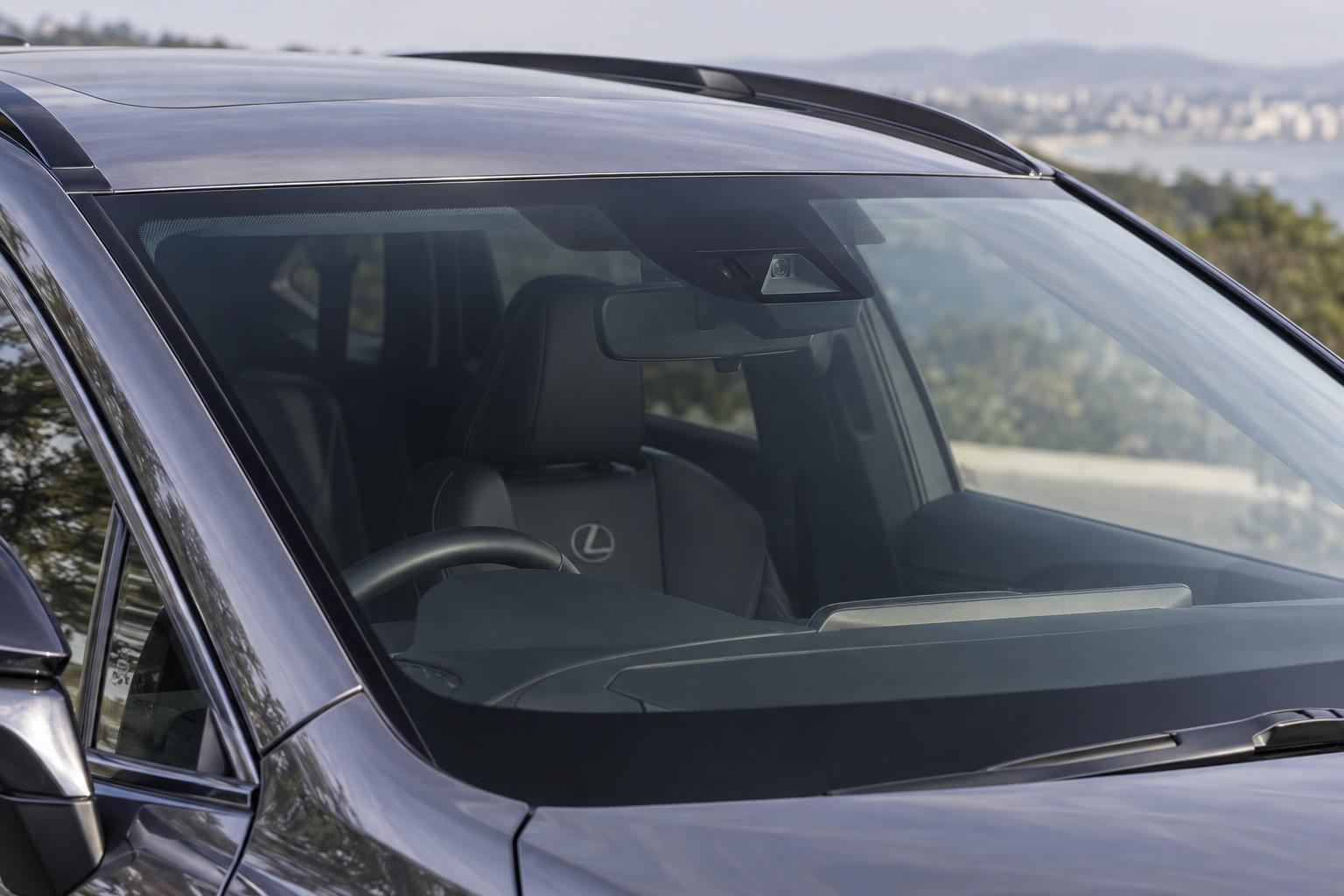 Close view of the forward-sensing camera area behind the windscreen of a Lexus NX.