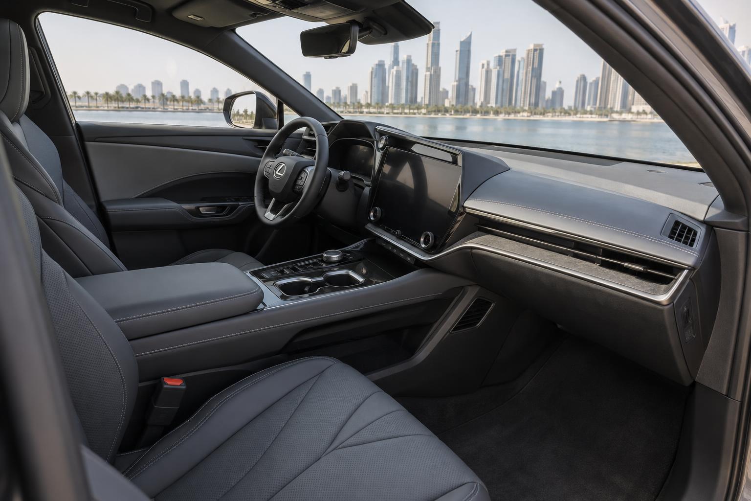 Front cabin of the Lexus RZ 500e Platinum AWD showing its dashboard and front seats.