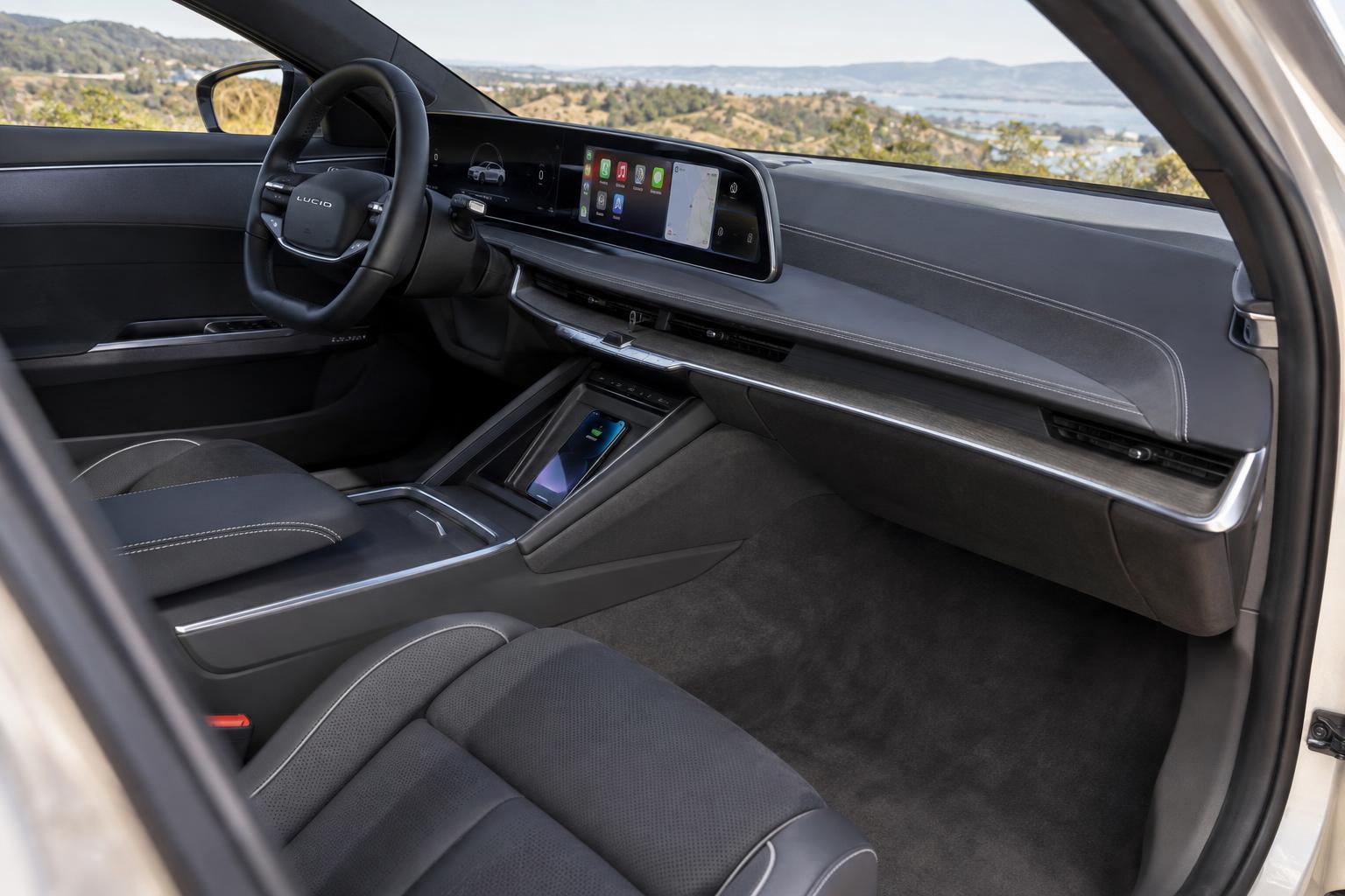 Lucid Air infotainment screen and smartphone illustrating expanded phone integration.