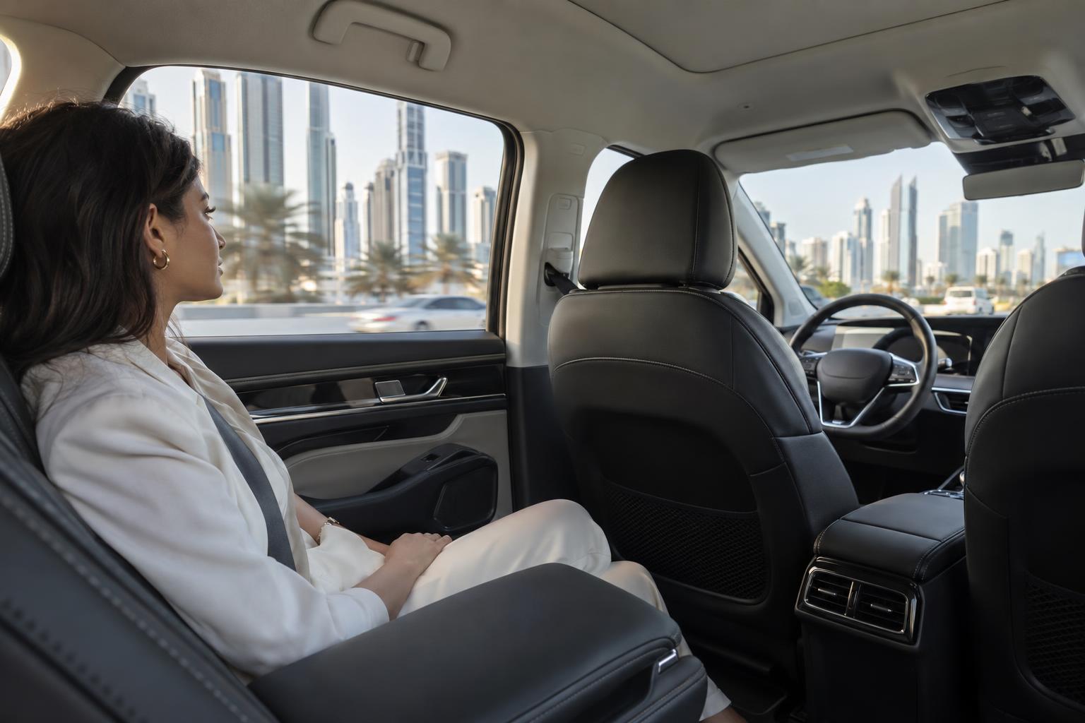 A passenger rides in the rear seat of an autonomous taxi with no driver in the front cabin.