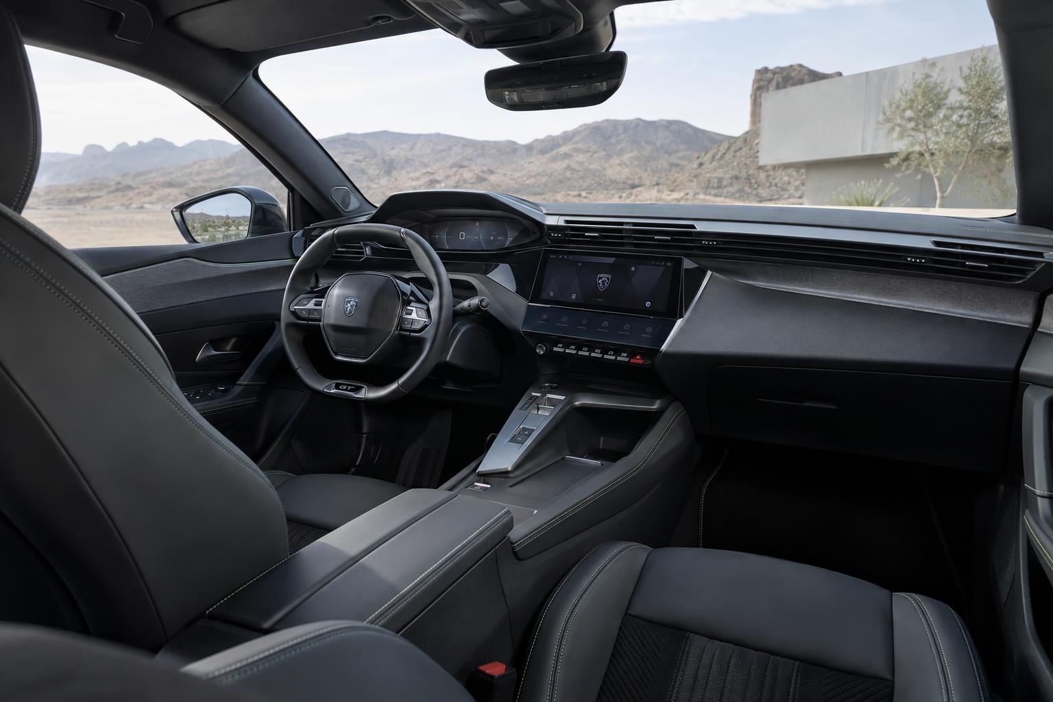 View into the redesigned Peugeot 408 cabin showing the driver-focused dashboard and front seats.