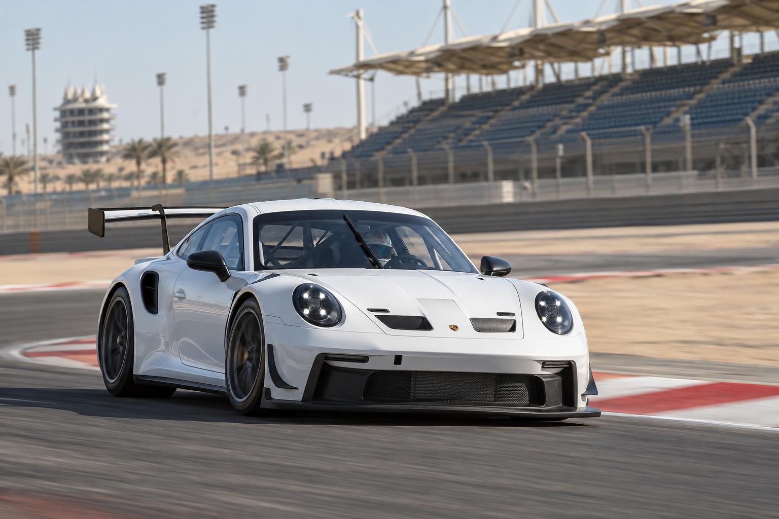 A Porsche 911 GT3 Cup car drives through a corner at Bahrain International Circuit.