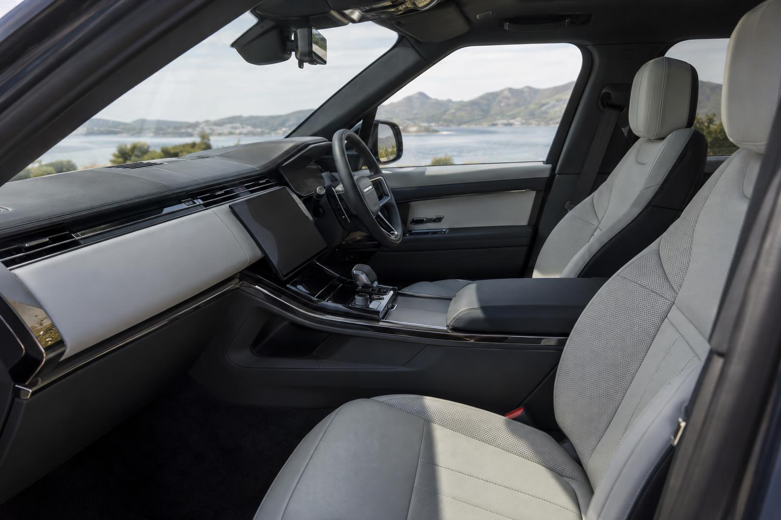 View across the front cabin of the Range Rover Sport Electric showing the dashboard and seats.