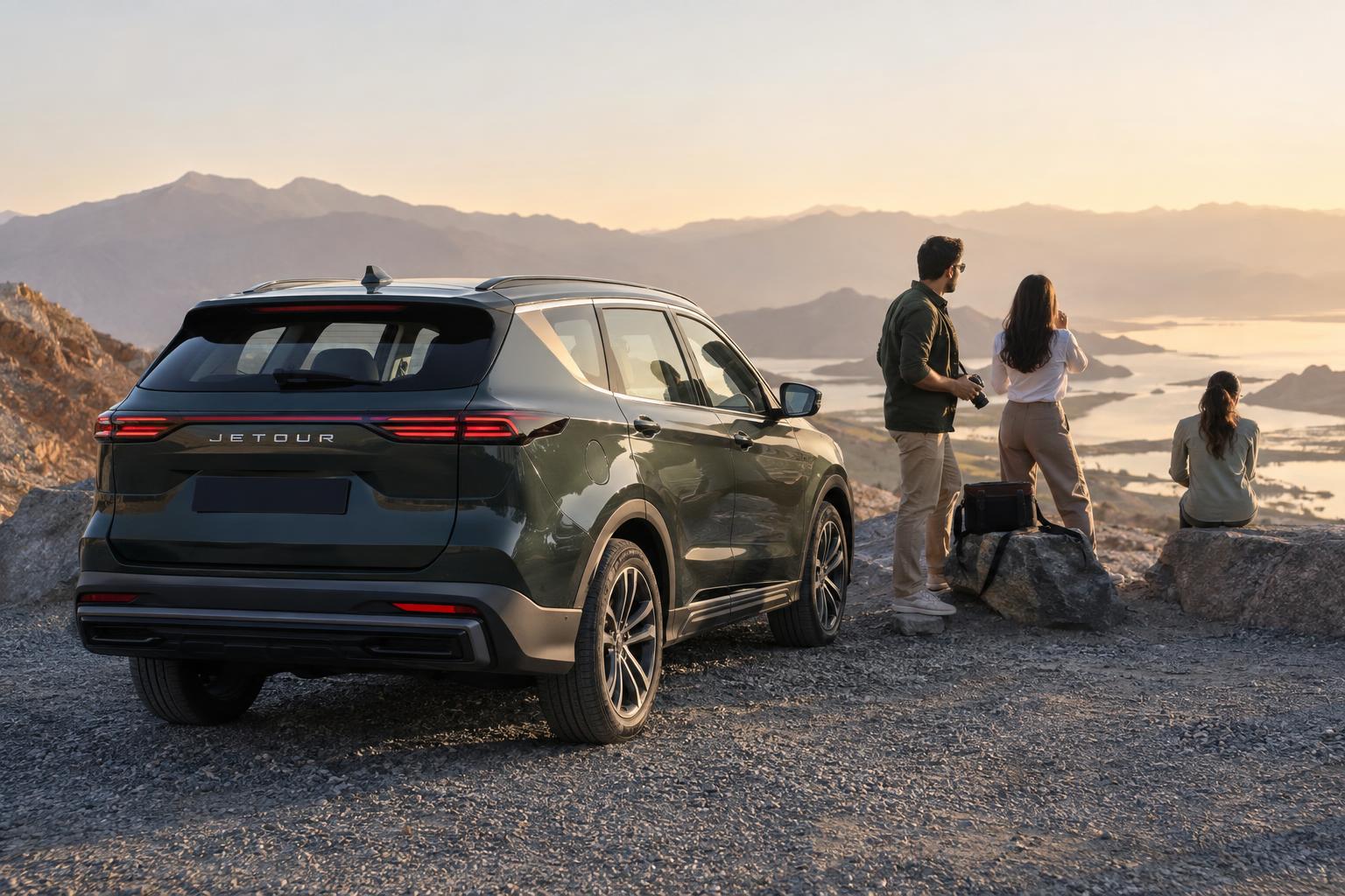 Travellers stop with a JETOUR SUV at a scenic UAE roadside viewpoint.