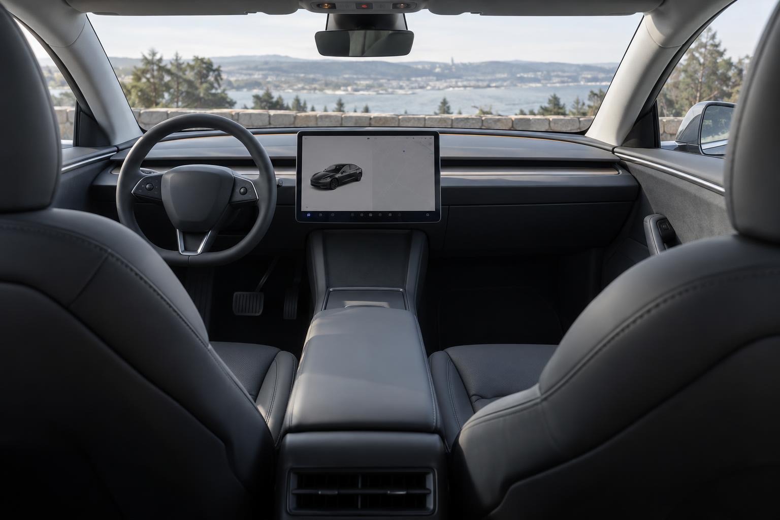 View across the front seating area of a left-hand-drive Tesla Model 3 cabin.