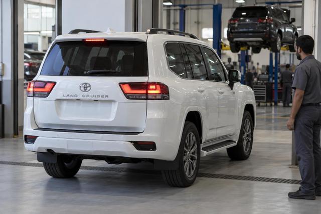 A Toyota Land Cruiser 300 arriving for inspection in a UAE dealership service bay.