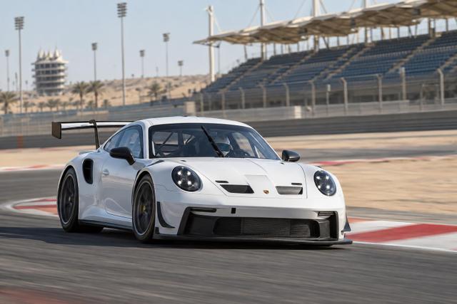 A Porsche 911 GT3 Cup car drives through a corner at Bahrain International Circuit.