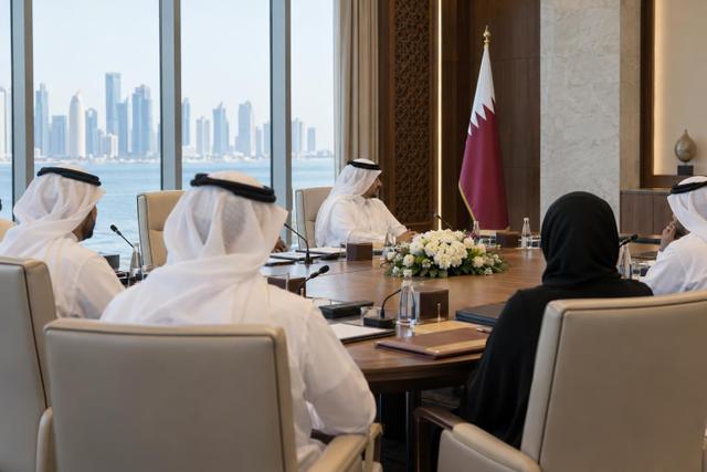 Officials seated in a formal Doha government meeting room with a Qatar flag in the background.