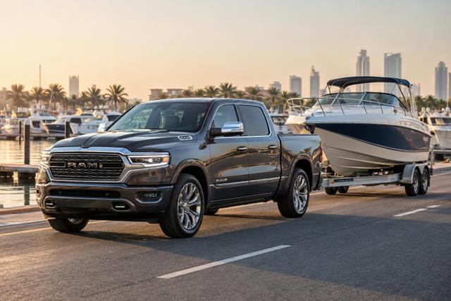 2026 Ram 1500 Limited towing an enclosed boat trailer beside a Gulf marina.