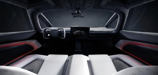 Tesla Roadster cabin with a yoke steering wheel, centre touchscreen and white seats with microsuede bolsters.