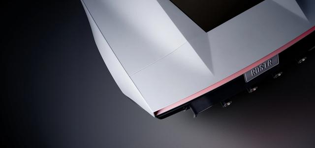 Rear of the Tesla Roadster showing the RDSTR plate and cold-gas thruster nozzles under the full-width taillight.