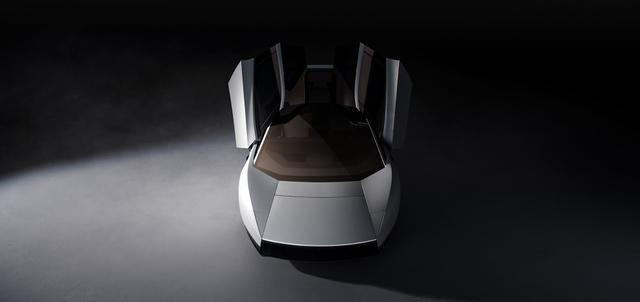 Overhead view of the Tesla Roadster with both upward-opening doors raised, showing the gold-tinted roof glass.